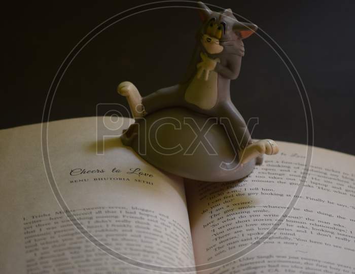 Closeup Of A Book And Toy Item Isolated On Black Background