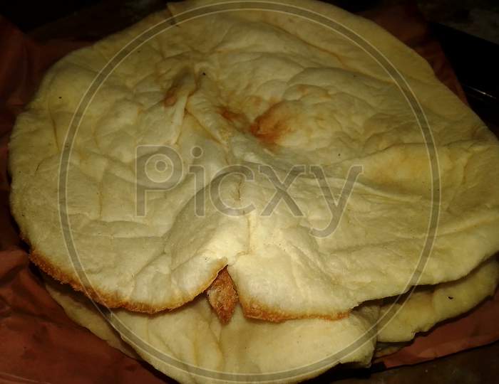 Naan Bread Close Up Photo Capture. Tandoori Naan. Bangladeshi And Indian Naan Roti. Naan Is A Leavened, Oven-Baked Flatbread Found In The Cuisines Mainly Of Western Asia, South Asia.