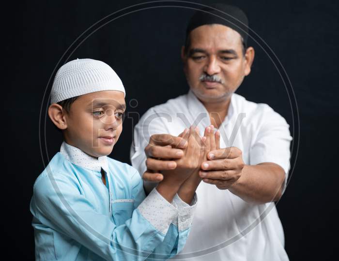 Muslim Father Teaching His Son How To Do Salah Or Payer In A Islamic Way.