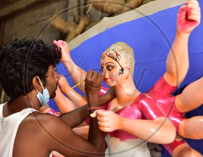 An artist gives final touches to an idol of Goddess Durga ahead of Durga Puja festival, in Guwahati, on Oct 16,2020