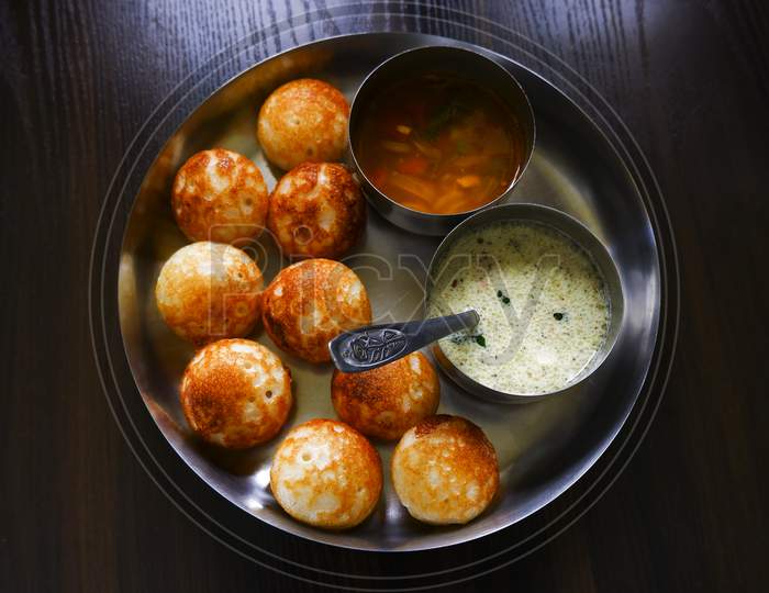 Top View Of Traditional South Indian Paddu (Rice Appe) With Sambar, Chutney Isolated In Plate On Wooden Table