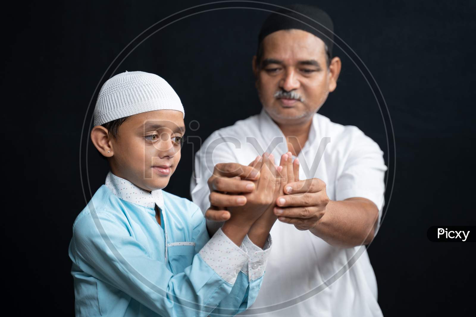 Muslim Father Teaching His Son How To Do Salah Or Payer In A Islamic Way.