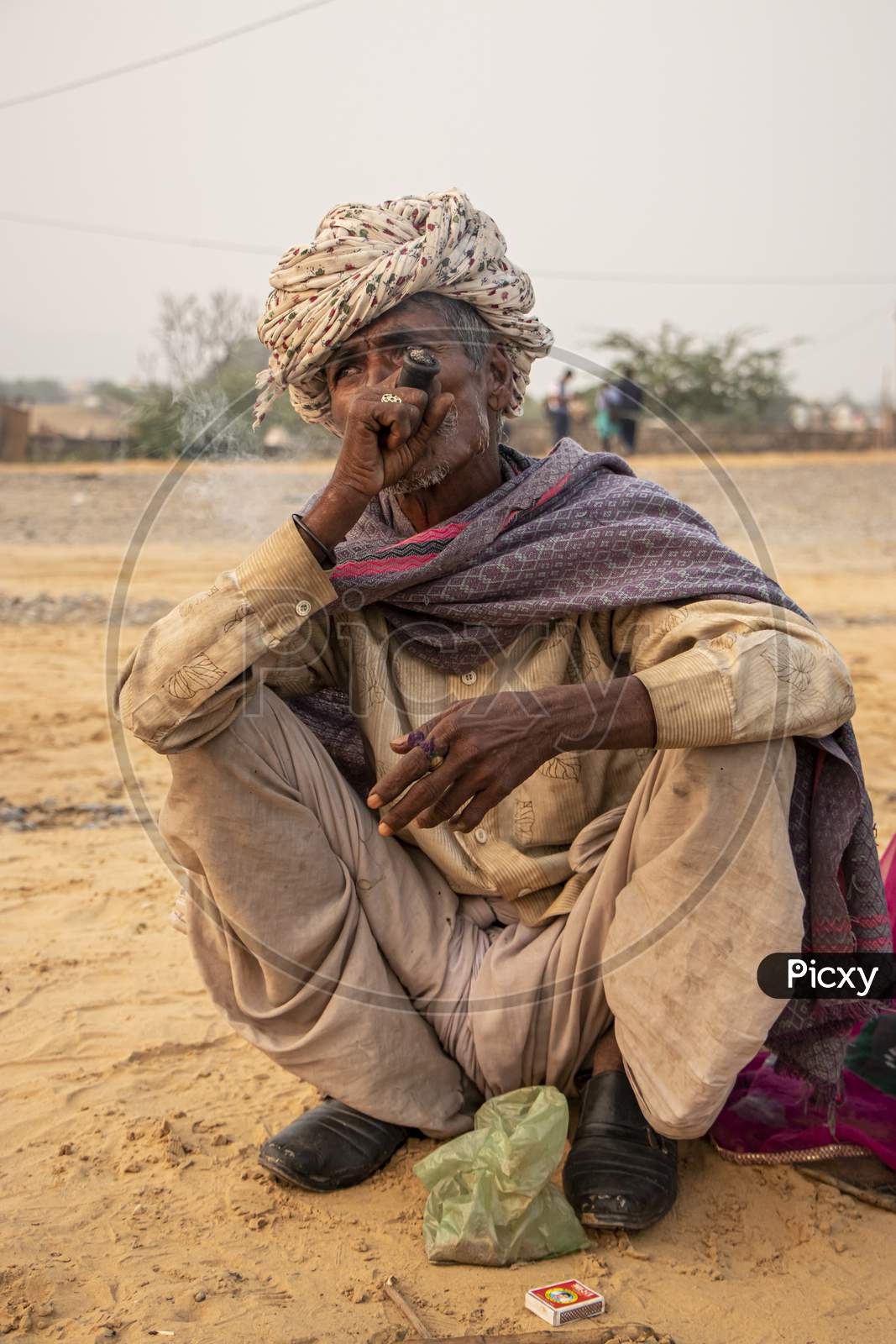 A tribal Rajasthani man smoking chillum