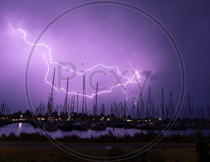 Lightning strike on the dark cloudy sky