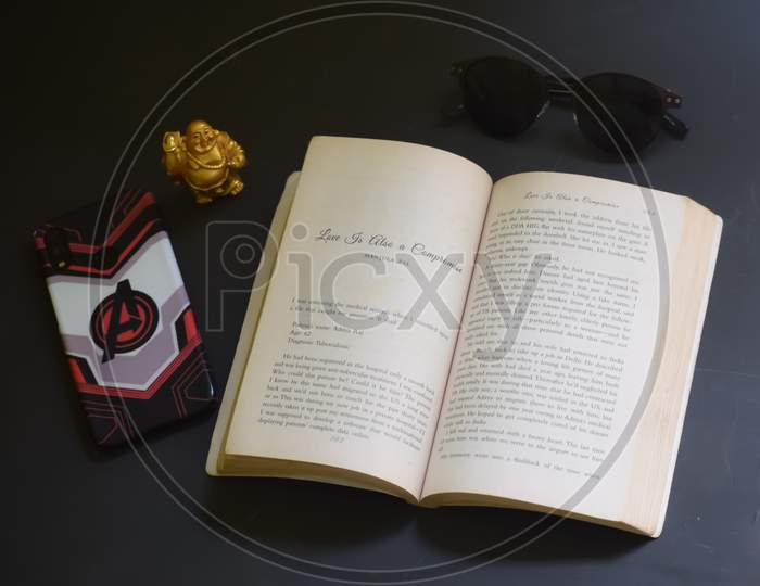 Closeup Of A Book With Other Tableware Items Isolated On Black Background