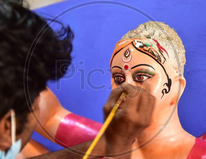 An artist gives final touches to an idol of Goddess Durga ahead of Durga Puja festival, in Guwahati, on Oct 16,2020