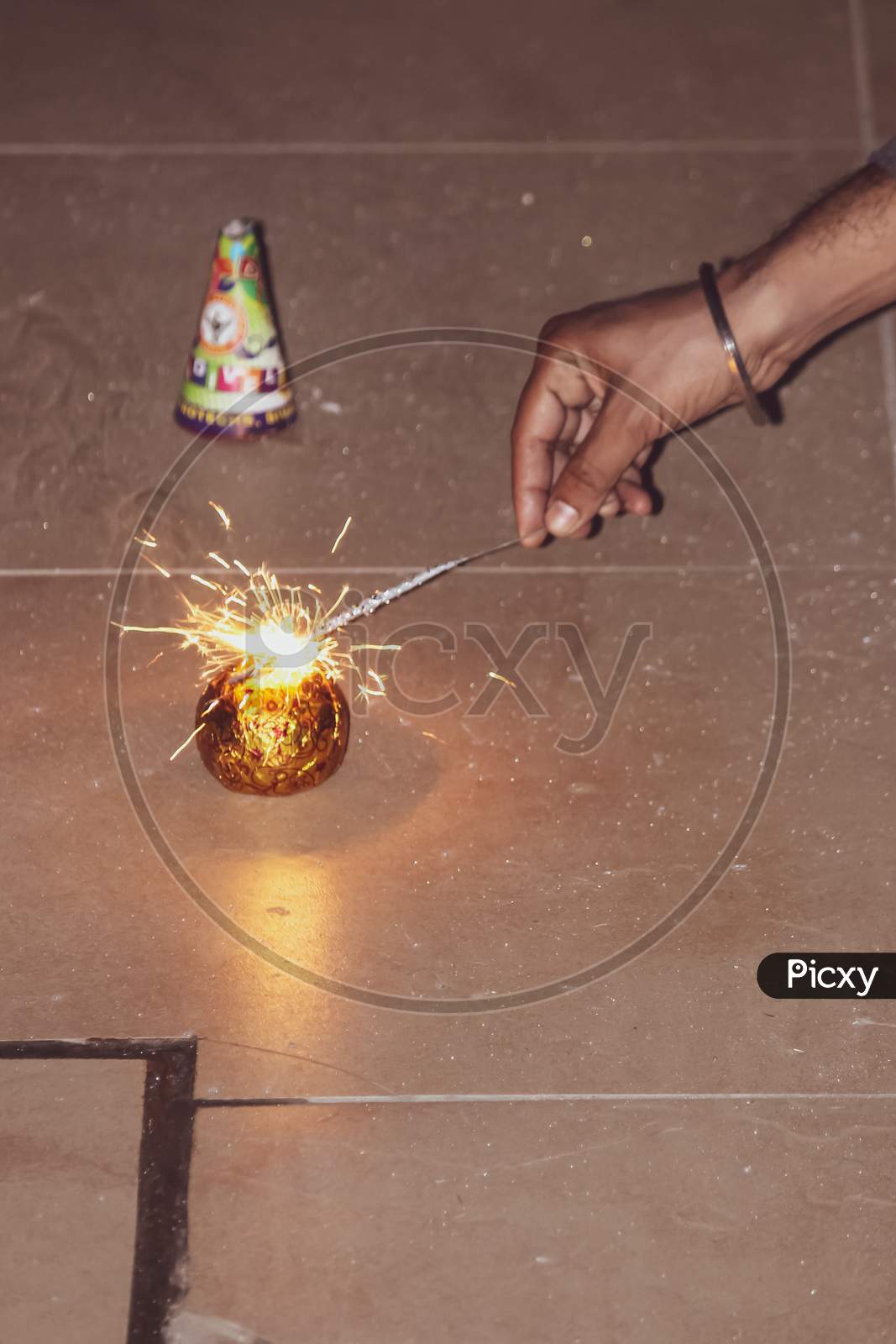 sparks of the fire coming out of the sparkler to burn the crackers during the festivals, celebration, diwali christmas