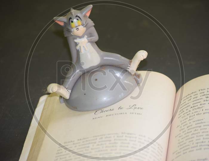 Closeup Of A Book With A Toy Item Isolated On Black Background
