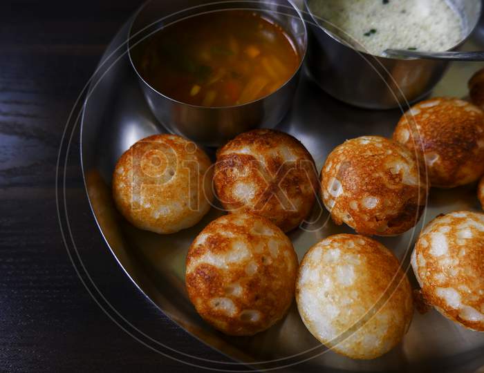 Close View Of Traditional South Indian Paddu (Rice Appe) Isolated In Plate On Wooden Table