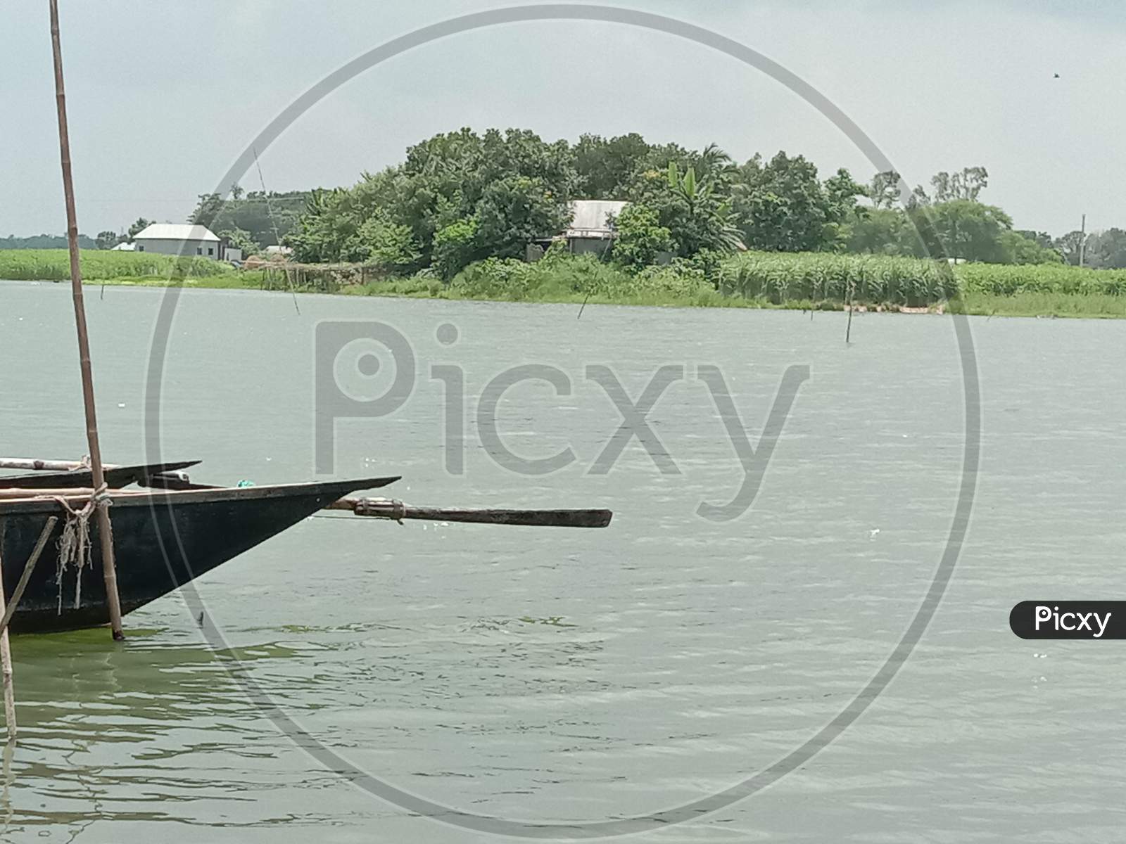 Black Colored Wooden Boat On River
