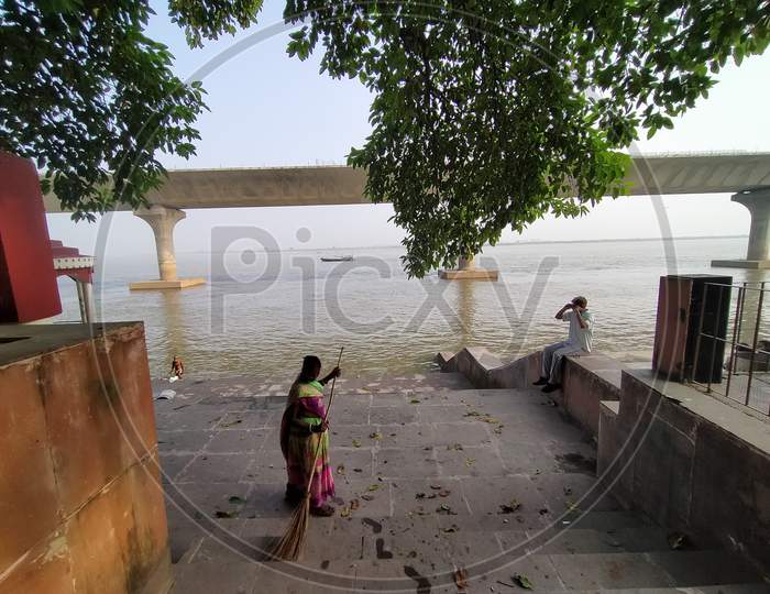 Morning street cleaning and yoga at bank ganga river