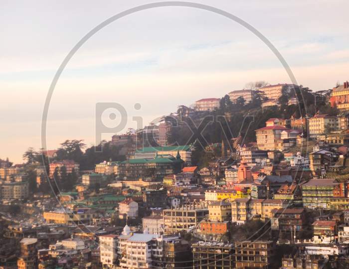 Buildings on hill slope in Shimla sunset time