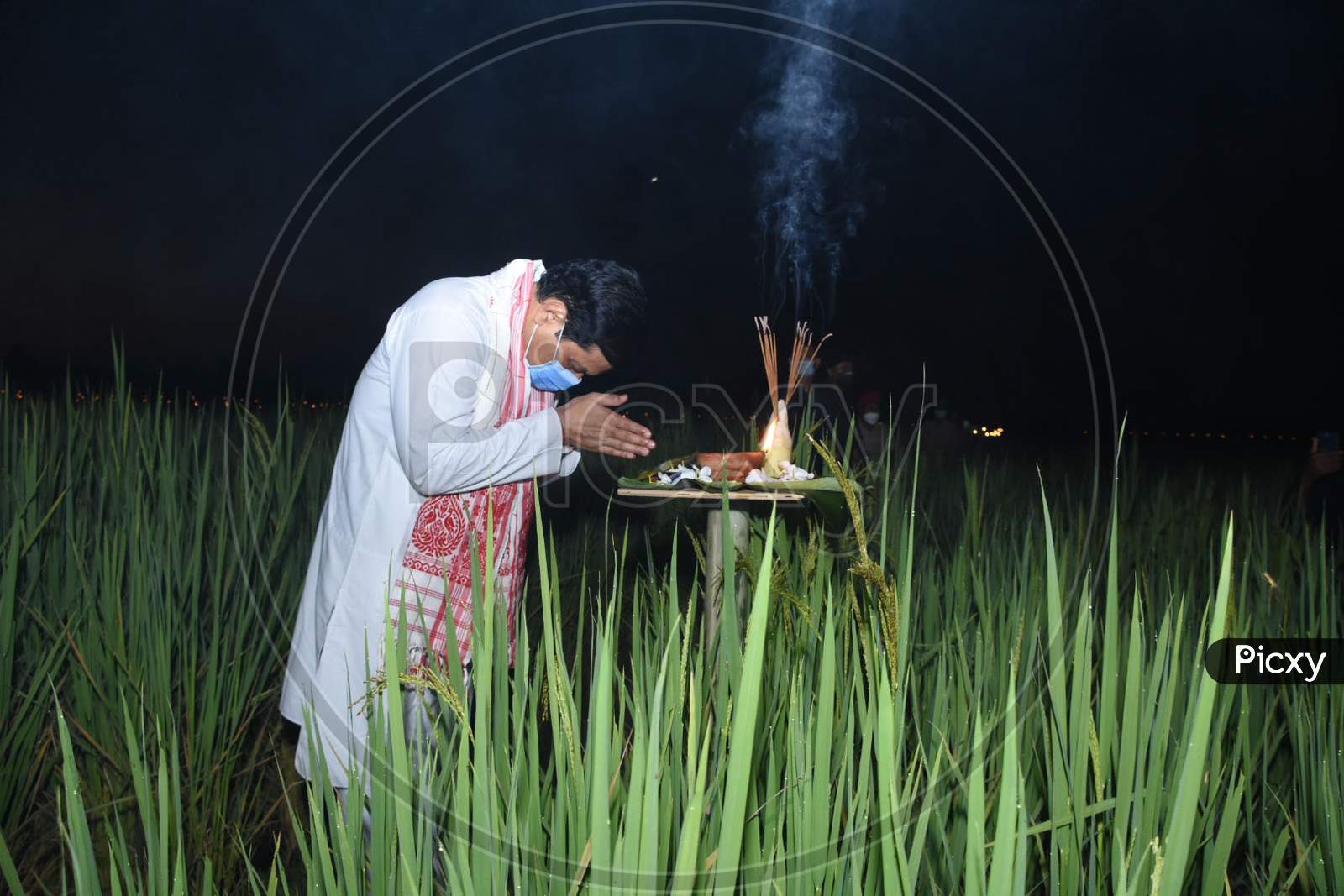 Assam Chief Minister Sarbananda Sonowal lighting akashbanti (earthen lamp) at a paddy field on the occasion of Kati Bihu at Bamunpara Monpur Pathar in Mangaldoi, in  Darrang district of Assam on oct 17,2020.