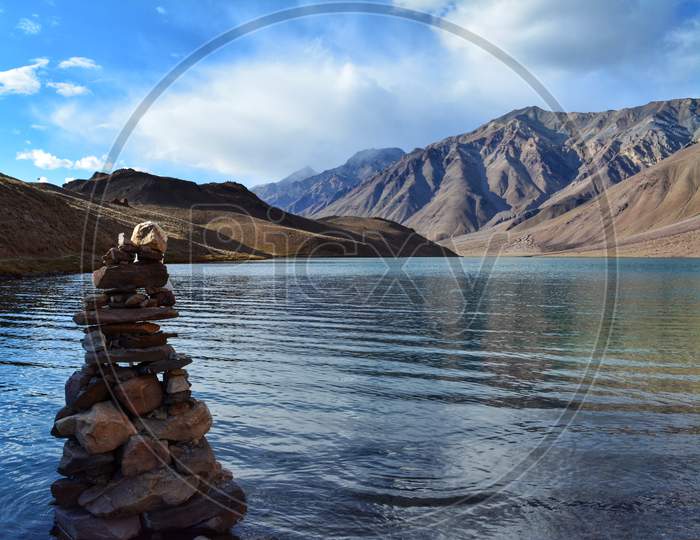 Close up of cairn with Chandratal Lake in the backdrop