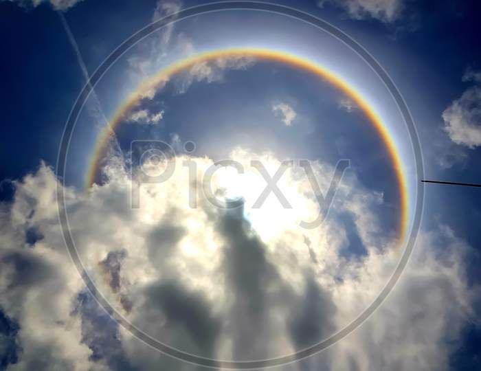 Circle rainbow sunlight cloud blue sky -photo 2020