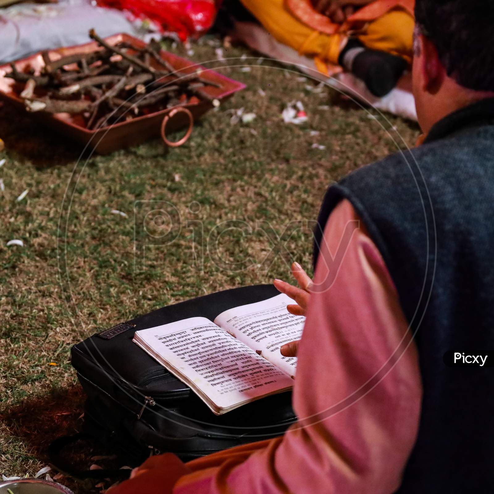 Indian Pandit Reading Out The Sacred Texts During Wedding