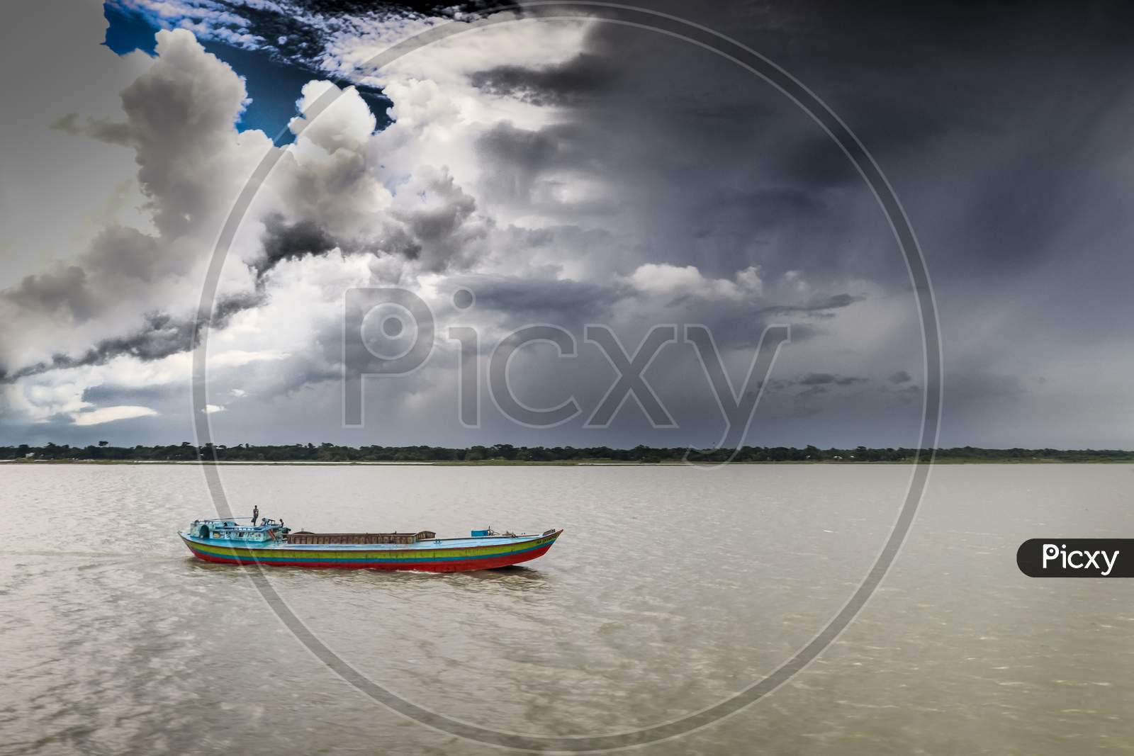 A Boatman Moving To City Under Summer Cloudy Sky
