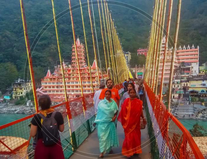 Some tourist waking across laxman jhula.Bridge in Rishikesh,uttarakhand,india.new pic 2020-21.