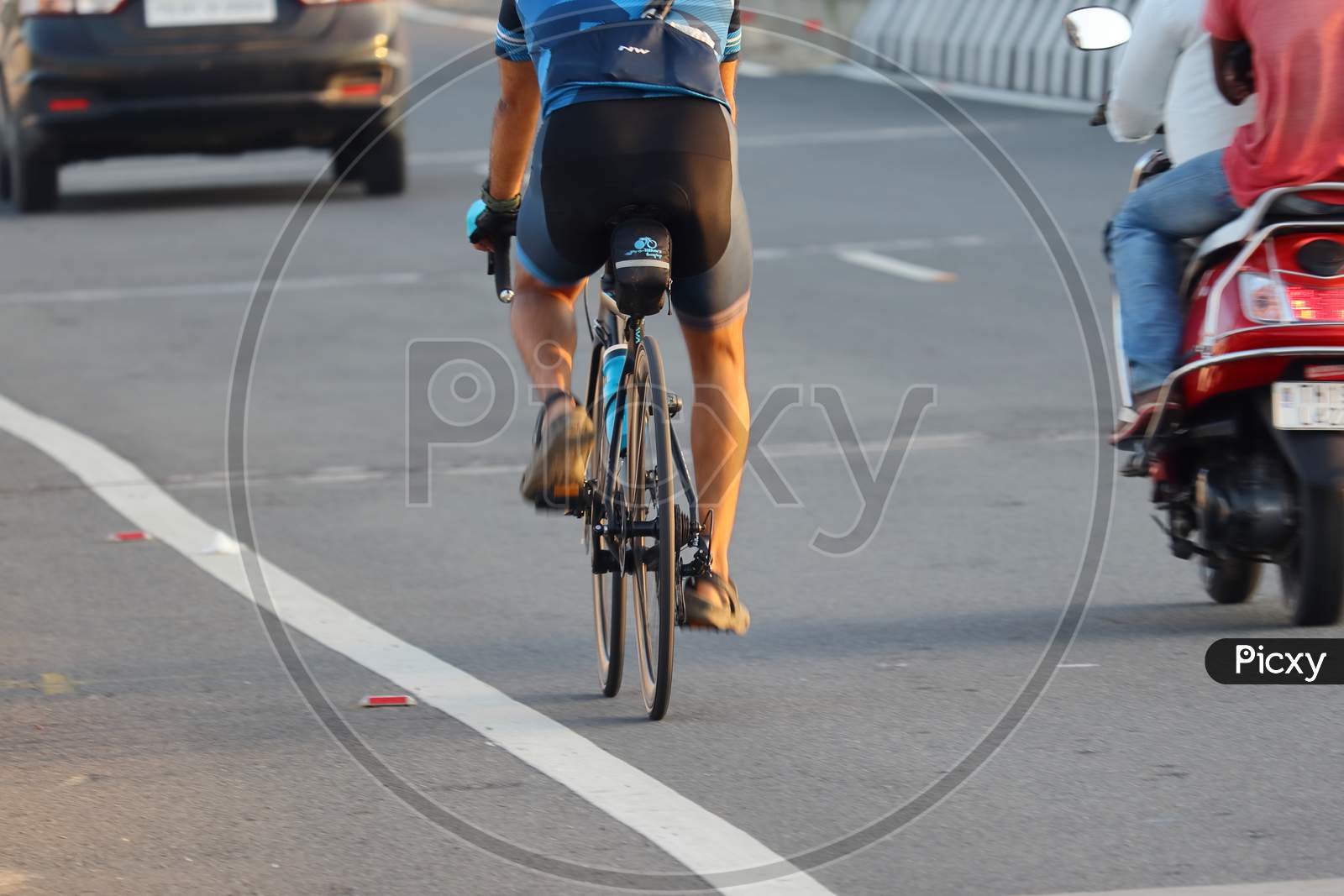 Young Sportsmen Cycling On Modern Gear Cycle On National Highway In The Morning