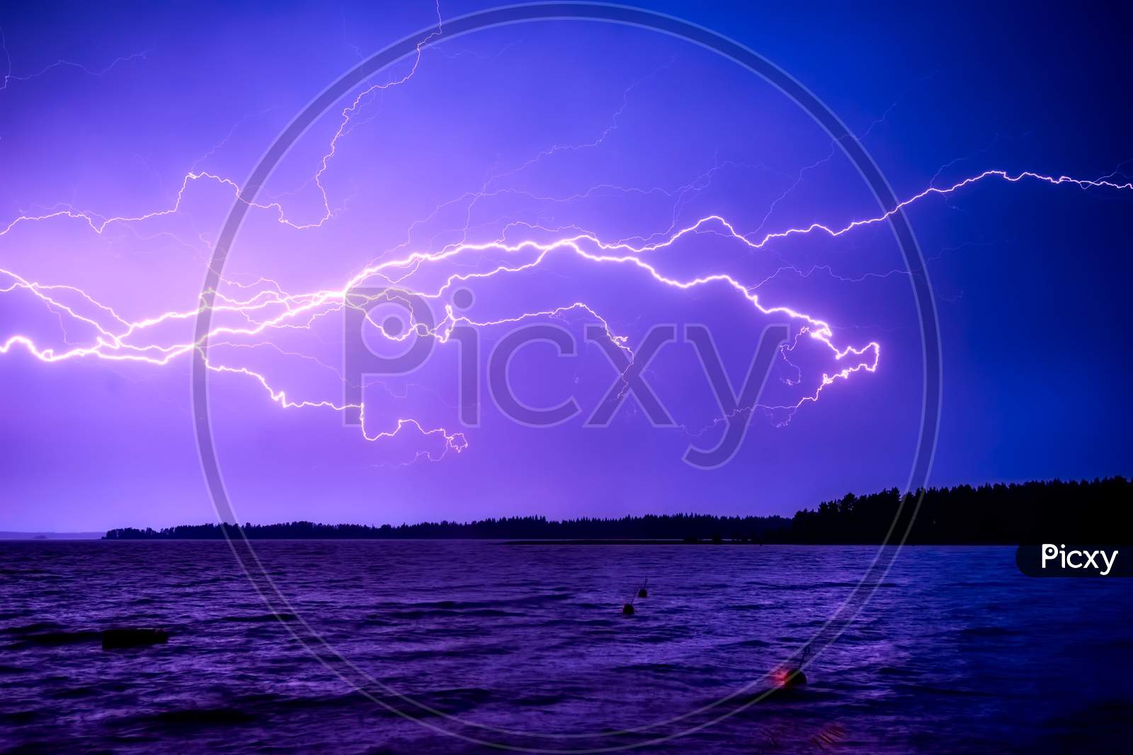Lightning over the sky- blue coloured lightning in the sky-lightning, storm, thunder, electricity, sky, bolt, electric,purple flash, weather, thunderstorm, night, abstract, light, rain, strike, energy, nature, cloudy day