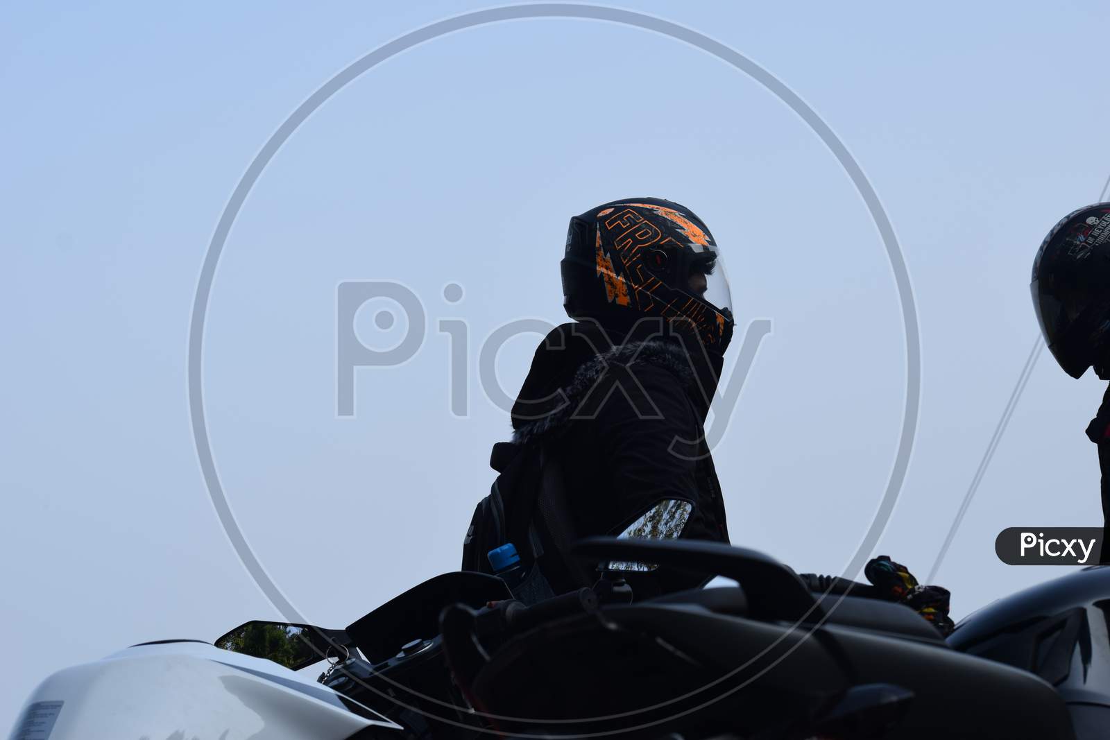 Closeup Of A Rider With Helmet Near To The Motorcycle