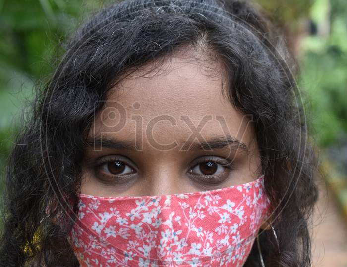 Face of a curly hair girl in mask