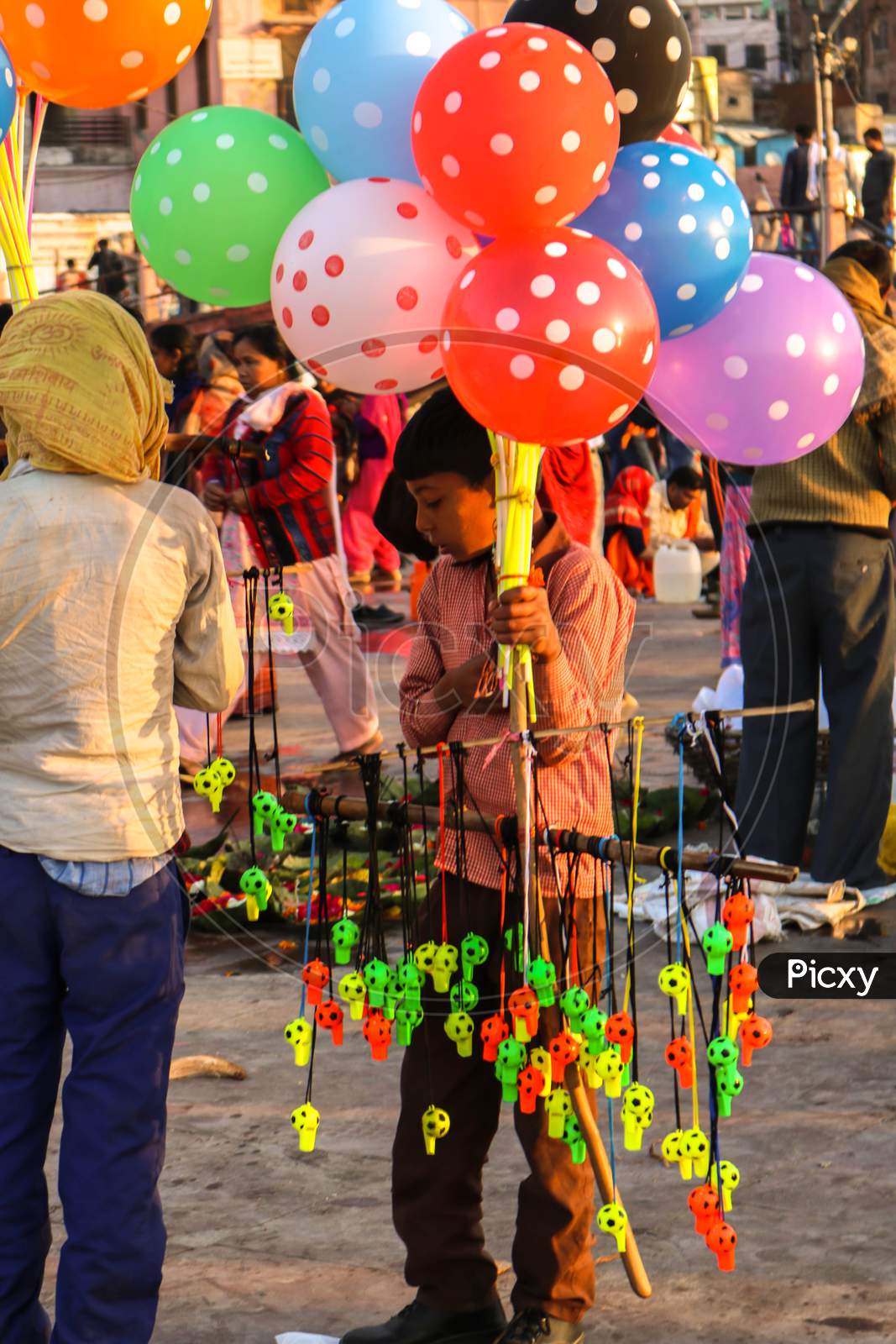 Little boy selling balloons