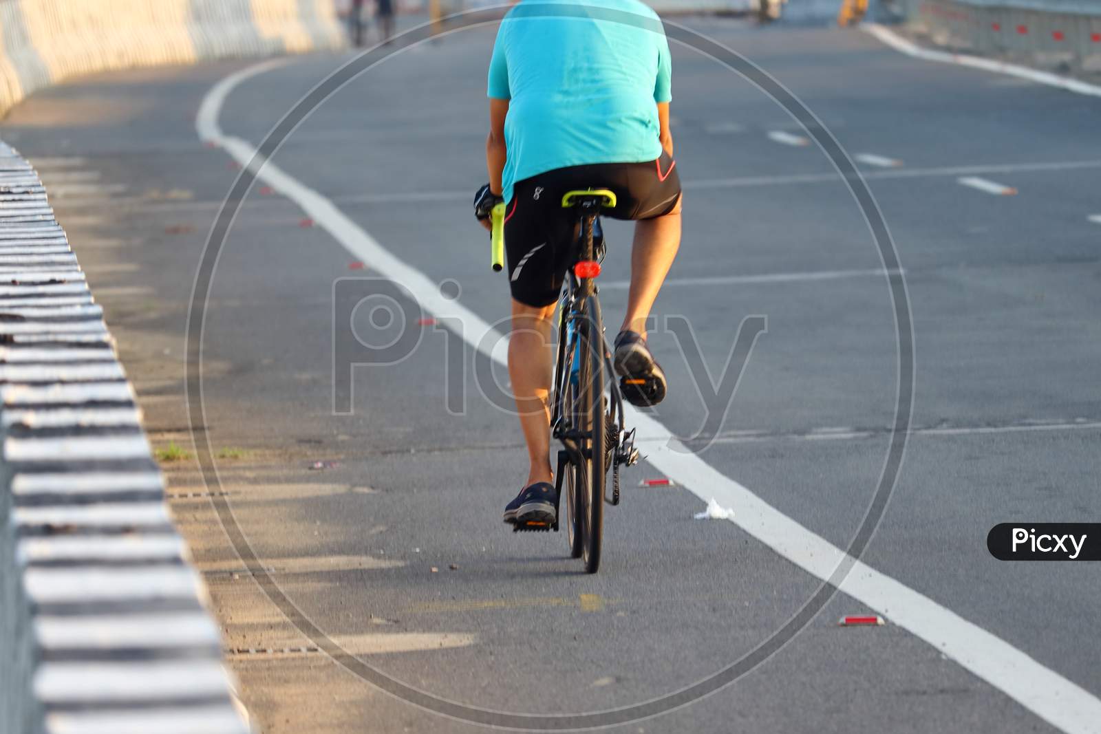 A Sports Man Enjoying Morning Cycling On Nation Highway Road