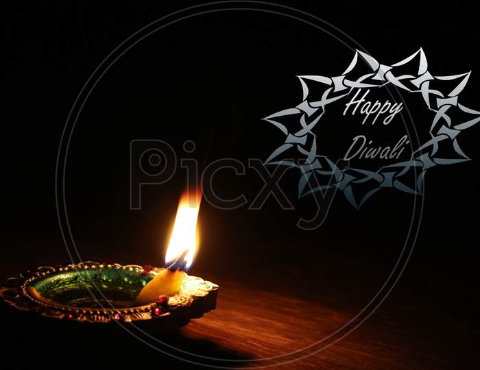 Glowing diya candles on a black background Happy diwali wish mesaage greetings