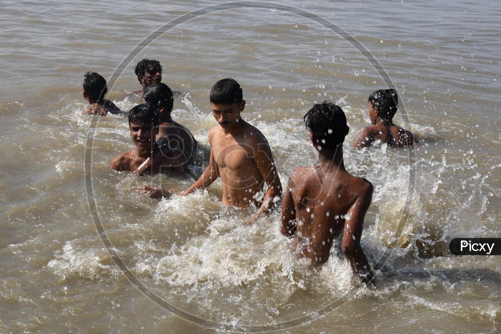 Boys jump in the Brahmaputra river during a hot day in Guwahati ,india on Oct 18,2020