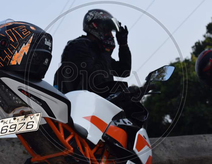 Closeup Of A Motorcycle With Helmet Near To The Rider