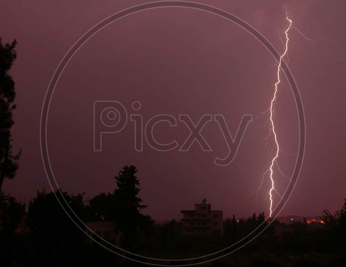 Lightning in the city-Purple coloured lightning in the sky-lightning, storm, thunder, electricity, sky, bolt, electric,purple flash, weather, thunderstorm, night, abstract, light, rain, strike, energy, nature, cloudy day