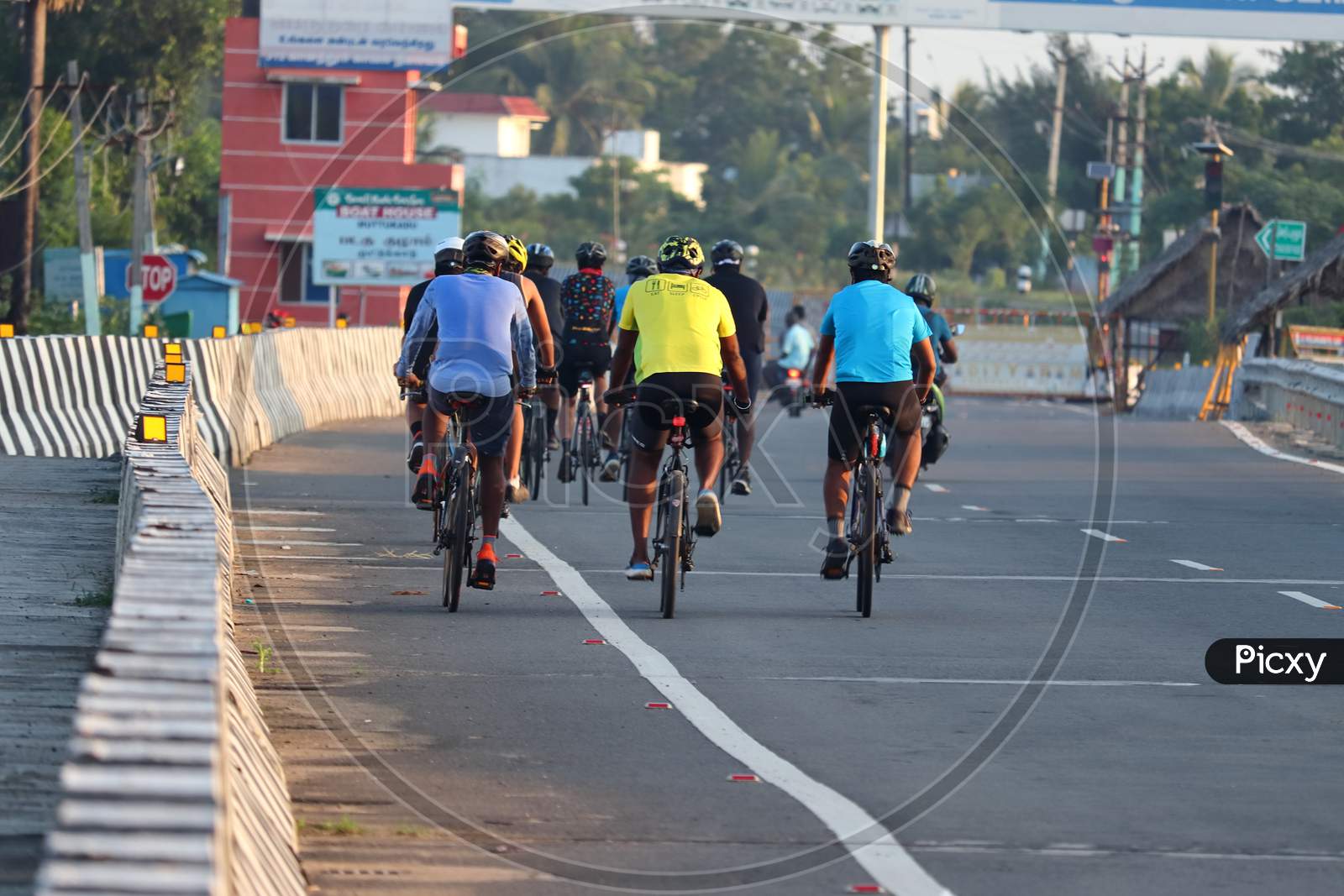 Young Sportsmen Cycling On The National Highway In The Morning