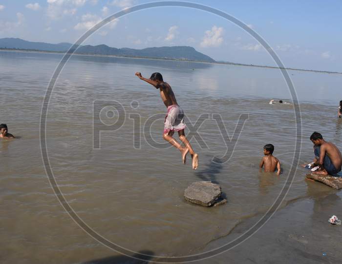 Boys jump in the Brahmaputra river during a hot day in Guwahati ,india on Oct 18,2020