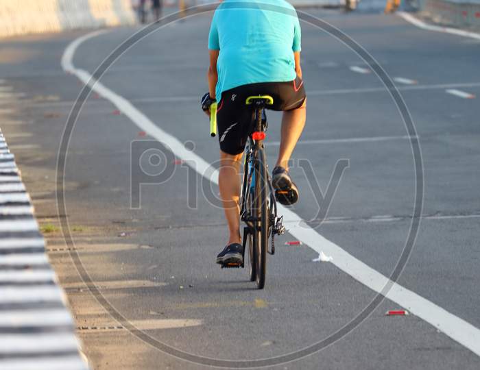 A Sports Man Enjoying Morning Cycling On Nation Highway Road