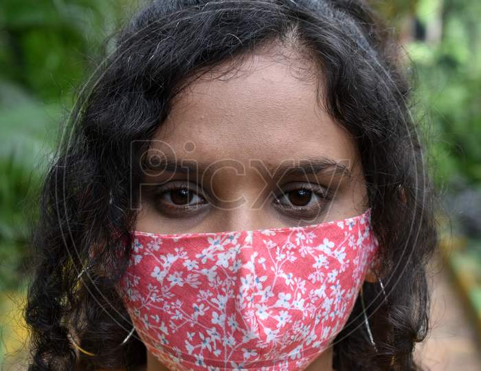 Face of a curly hair girl in mask
