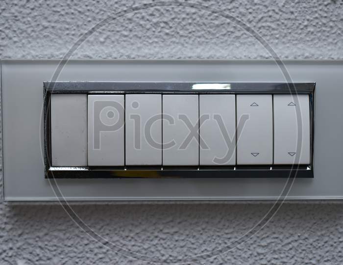 Designer Electrical Switch Board On Zinc Paint Wall With Six Switches