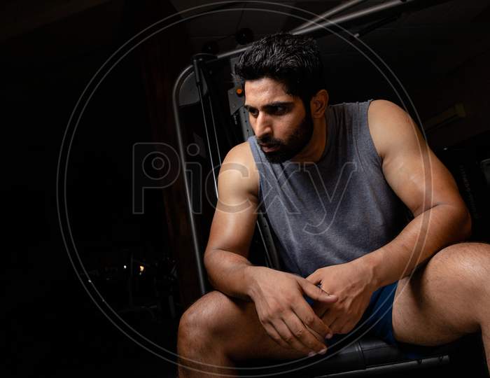 Man Sitting On Table After Heavy Workout And Full On Sweating