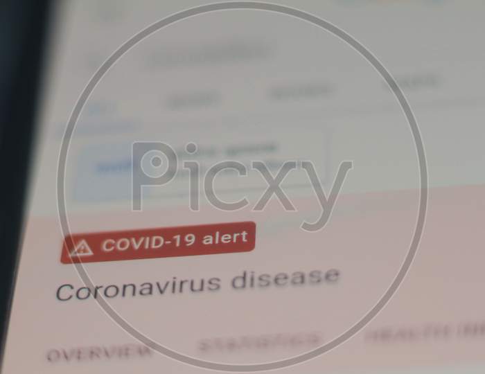 Coronavirus News.News On The Phone.Mobile Phone In Hands With # Stay At Home.Quarantine And Flash Warning On A Mobile Phone.Stay Home To Stop The Spread Of Covid-19 Coronavirus. Global Covid-19