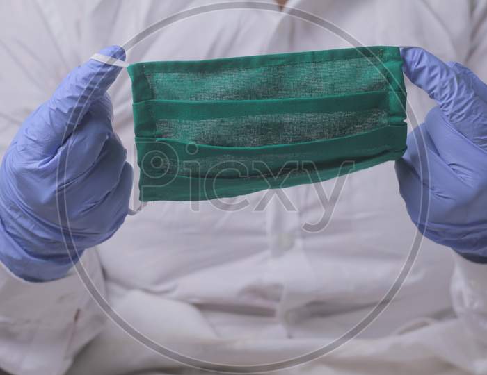 Close Up Of Doctor'S Hand With A Medical Face Mask For Protection Against Infection