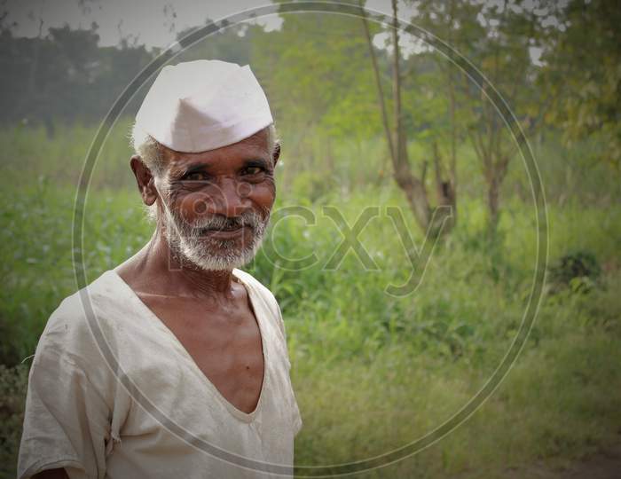 happy face of farmer in pain also