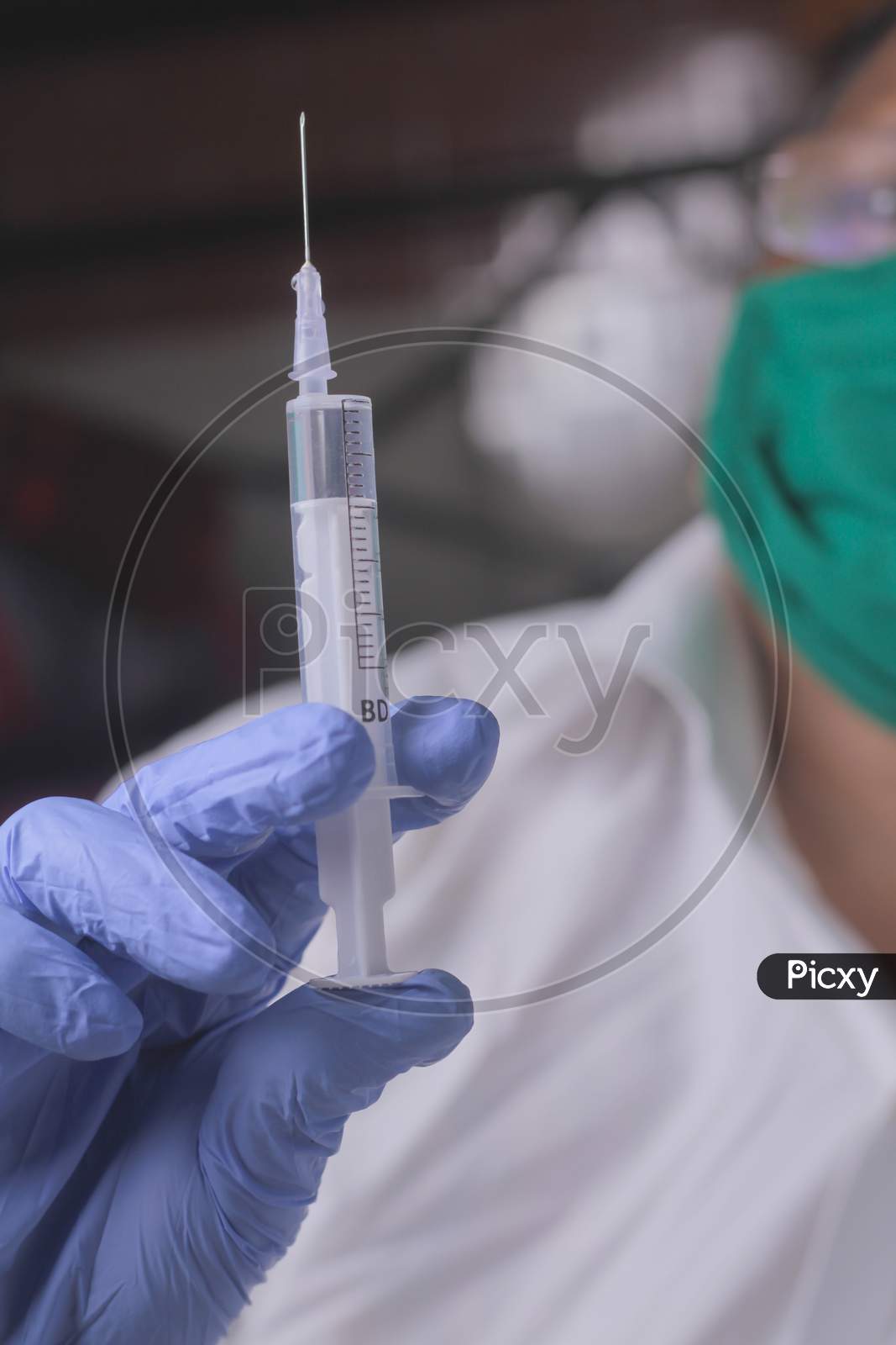 Close Up Of Women Doctor Holding Syringe With Injection