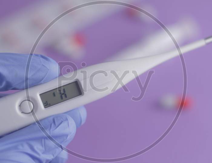 Close Up Man Hand Holding Thermometer. Health Care And Medical Concept.