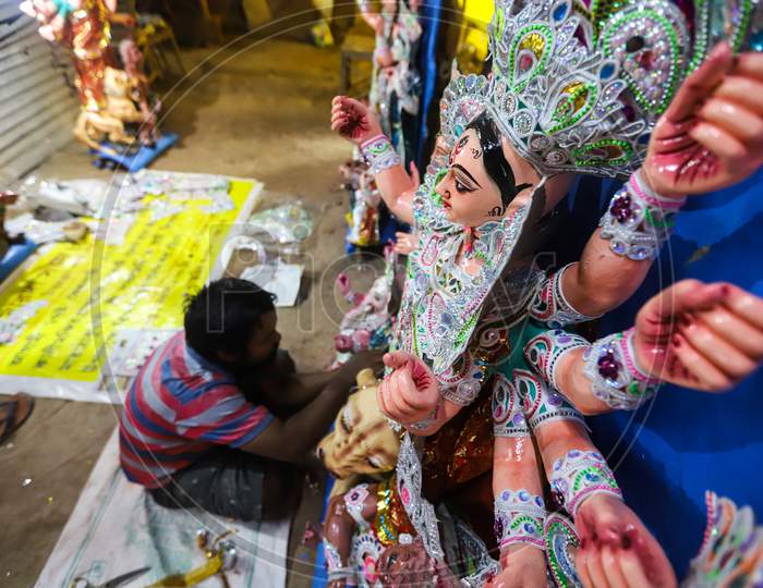 An artist giving final touches to the idol of Hindu Goddess Durga ahead of Durga Puja festival in CR Park, New Delhi on October 19, 2020. Bengalis all over the world celebrate an annual Durga puja festival.