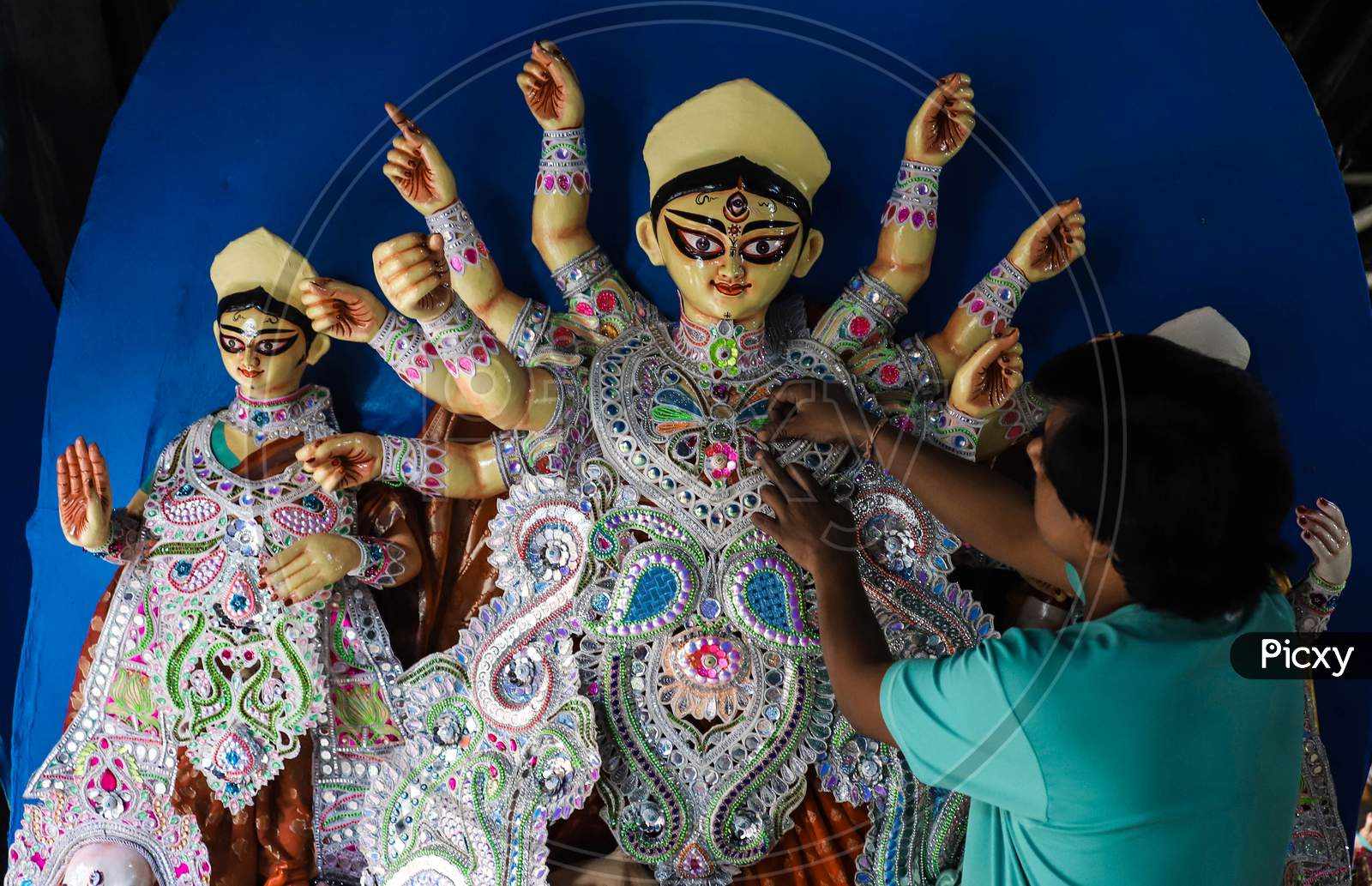 An artist giving final touches to the idol of Hindu Goddess Durga ahead of Durga Puja festival in CR Park, New Delhi on October 19, 2020. Bengalis all over the world celebrate an annual Durga puja festival.