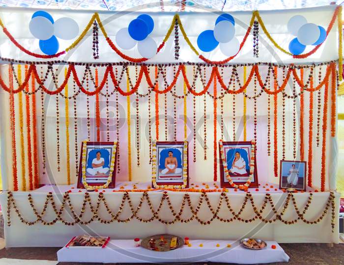 Decoration of Thakur Anukulchandra and his family member's photo frames
