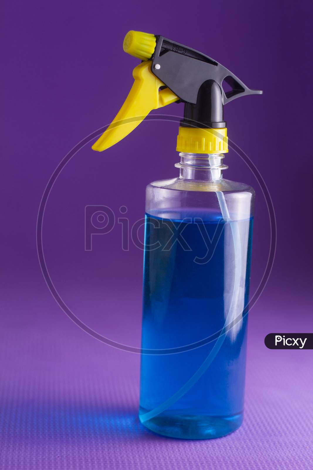 Blue Hand Sanitizer Spray Bottle On Violet Color Background