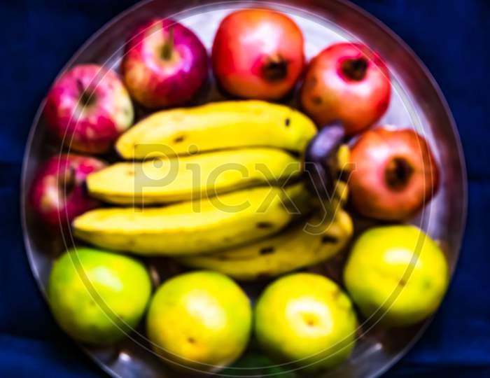 Blurred out of focus fruits on plate background