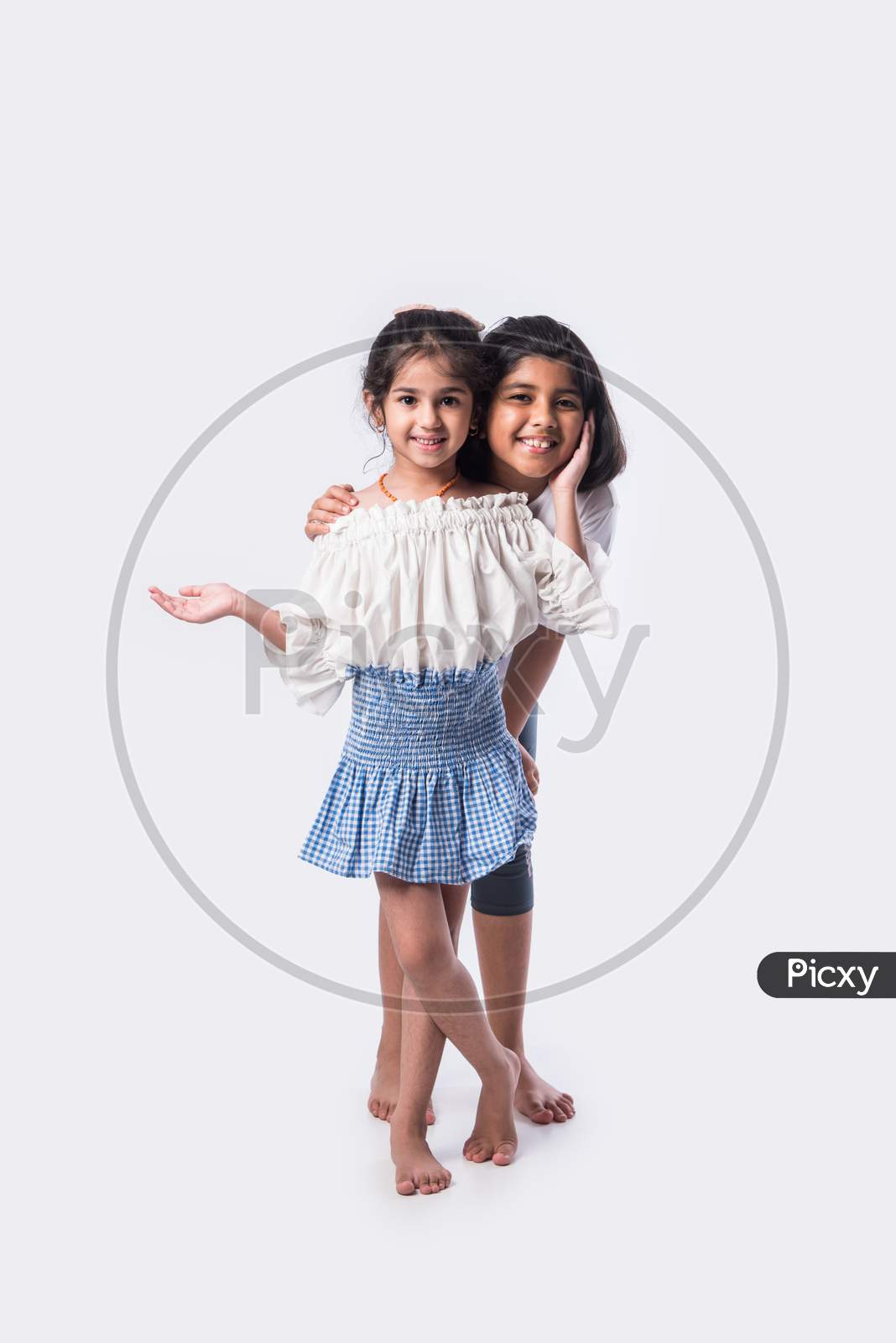 Cute Little Indian Asian Siblings Standing Together Close Isolated Against White Background