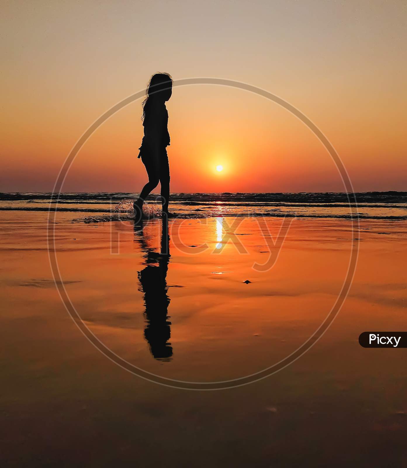 Too beautiful view of sunset and a child playing at seashore